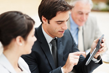 Business man making calculations during a meeting