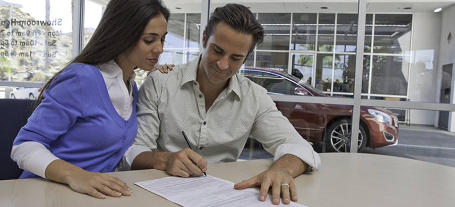 Man and woman signing papers